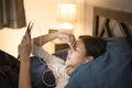 young woman is using tablet   watching movies or video call to her friends or family in her bedroom   night Light Royalty Free Stock Photo