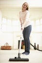 Young Woman Using Vacuum Cleaner