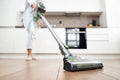 Young Woman Vacuuming the Floor. Vacuuming and Cleaning the House Royalty Free Stock Photo