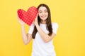 Young woman valentines day concept, girl with heart shaped card. Lovely charming girl holding in hands heart love symbol