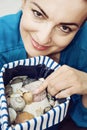 Young woman with various shells in sailor bag