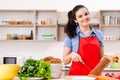 Young woman with vegetables in the kitchen Royalty Free Stock Photo