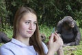 Young woman veterinarian in the background of the chimpanzee family