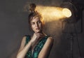 Young Woman in Vintage Dress Standing in Spotlight Royalty Free Stock Photo