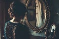 A young woman in a vintage interior design before the mirror Royalty Free Stock Photo