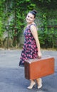 Young woman in vintage skirt with and old suitcase Royalty Free Stock Photo