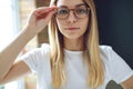 Young woman with vision problems wearing glasses. The girl wears glasses. Royalty Free Stock Photo