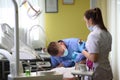 Young woman visiting dentist at clinic. Male dentist with patient in clinic Royalty Free Stock Photo