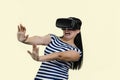 Young woman in vr headset is stratched her hands in fear. Royalty Free Stock Photo