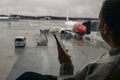 Woman waiting at the airport using her smartphone Royalty Free Stock Photo