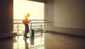 young woman waiting for flying at airport at window with suitcase . Royalty Free Stock Photo