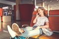 young woman waiting for flying at airport at window with suitcase Royalty Free Stock Photo