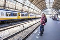 Young woman waiting for the train at central station Amsterdam Royalty Free Stock Photo