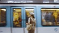 Young woman waiting for a train at the station in Paris Royalty Free Stock Photo