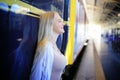 Young woman waiting train, relaxed and carefree at the station platform in Bangkok, Thailand before catching a train. Royalty Free Stock Photo