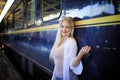 Young woman waiting train, relaxed and carefree at the station platform in Bangkok, Thailand before catching a train. Royalty Free Stock Photo