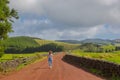 Young woman walk at country road. Fields with blue sky. Terceira Royalty Free Stock Photo