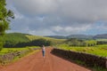 Young woman walk at country road. Fields with blue sky. Terceira Royalty Free Stock Photo