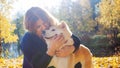 Young woman on a walk with her dog breed Akita inu.