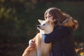 Young woman on a walk with her dog breed Akita inu. Royalty Free Stock Photo