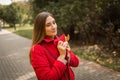 Young woman on a walk in the park in autumn in fine weather