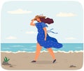 Young womanis walking alone on coastline. Lady hold her hat on head because of windy weather