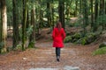 Young woman walking alone on a forest