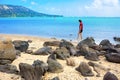 Young woman walking alone on rocky Hawaiian beach Royalty Free Stock Photo