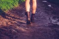 Young woman walking along muddy trail Royalty Free Stock Photo