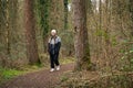 Young woman walking along a trail in a serene forest