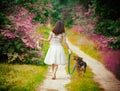 Young woman walking barefoot with dog Royalty Free Stock Photo