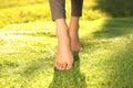 Young woman walking barefoot on fresh green grass, closeup Royalty Free Stock Photo