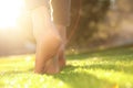 Young woman walking barefoot on fresh green grass, closeup Royalty Free Stock Photo