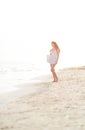 Young woman walking on beach in the evening Royalty Free Stock Photo