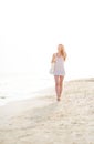 Young woman walking on beach in the evening Royalty Free Stock Photo