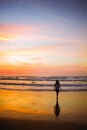 Young woman walking at the beach at sunrise in Ubatuba, Sao Paulo, Brazil Royalty Free Stock Photo