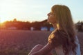 Young woman walking on beach under sunset light, Royalty Free Stock Photo