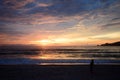 Young woman walking on beach under sunset light Royalty Free Stock Photo