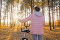 Young woman walking with bicycle in autumn city park - backview Royalty Free Stock Photo