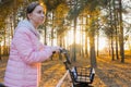 Young woman walking with bicycle in autumn city park Royalty Free Stock Photo