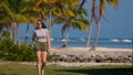 Young woman walking on a Carribean Paradise beach Royalty Free Stock Photo