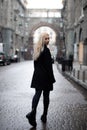 young woman walking city streets and look behind at camera Royalty Free Stock Photo