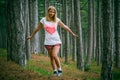 Young Woman walking in Coniferous deep Forest