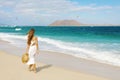 Young woman walking on Corralejo wild beach looking at Lobos Island on the background, Fuerteventura, Canary Islands Royalty Free Stock Photo