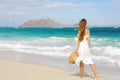 Young woman walking on Corralejo wild beach looking at Lobos Island on the background, Fuerteventura, Canary Islands Royalty Free Stock Photo