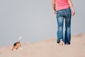 Young woman walking with dog on beach Royalty Free Stock Photo