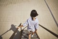 Young woman walking down the stairs Royalty Free Stock Photo