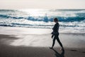 Young woman walking on an empty black sand beach Royalty Free Stock Photo