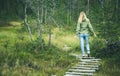 Young Woman walking in forest wooden road alone