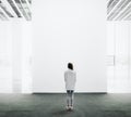 Young woman walking through a gallery and looking